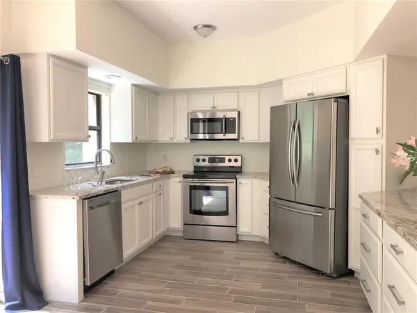 a view of a kitchen counter space and stainless steel appliances