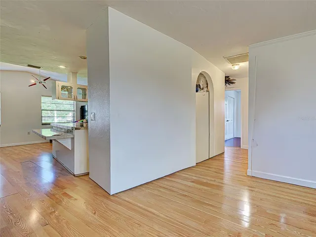 a view of a hallway with wooden floor