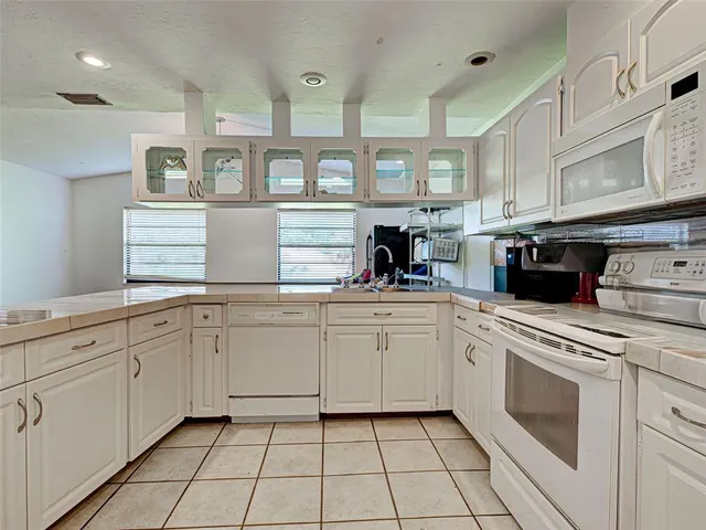 a kitchen with cabinets and appliances
