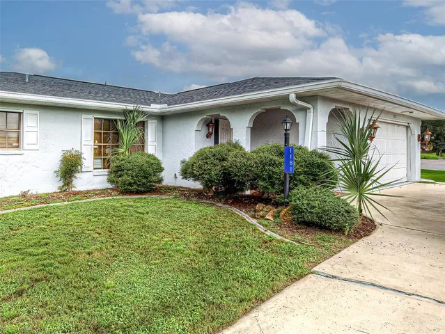 a front view of house with yard and green space