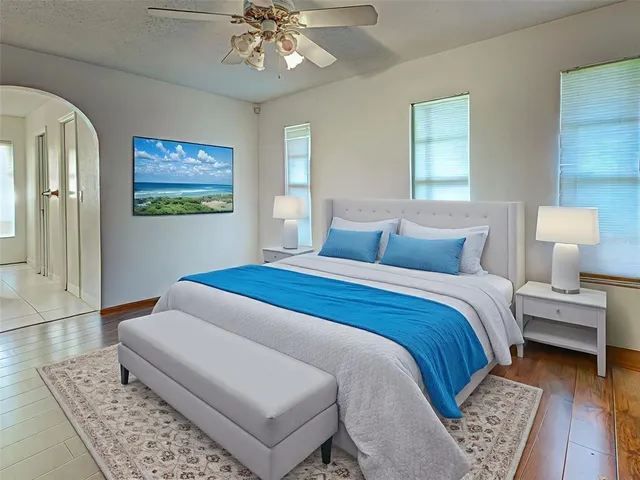 a bedroom with a bed and a chandelier