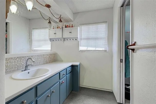 a bathroom with a sink vanity and a mirror