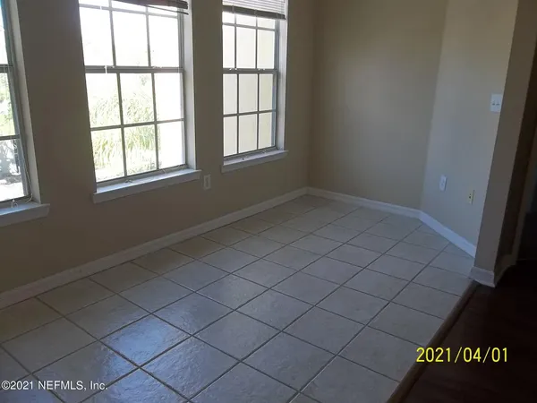a view of kitchen with wooden floor and electronic appliances