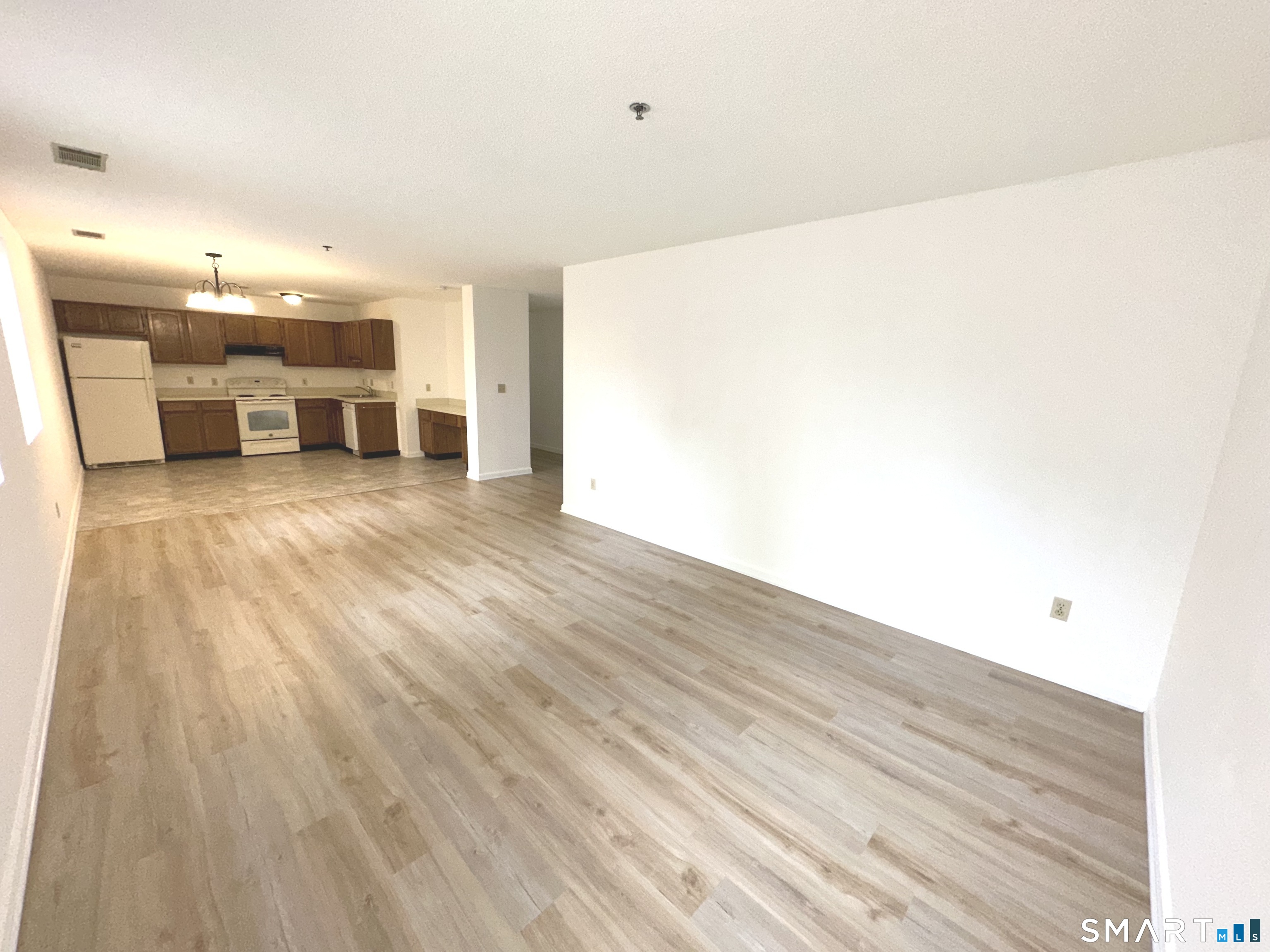 243 Judd Square, Unit 243 Wallingford, CT 06492 - Photo 6 of 17 a view of a room with wooden floor