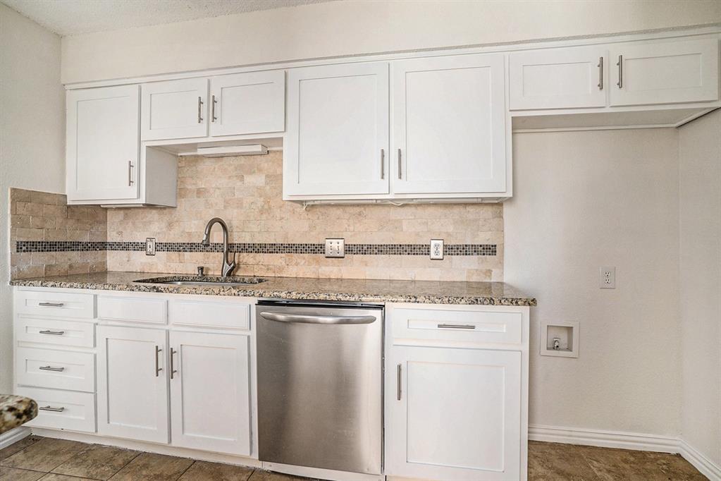 602 McAnear Street Cleburne, TX 76033 - Photo 12 of 27 a kitchen with white cabinets and sink