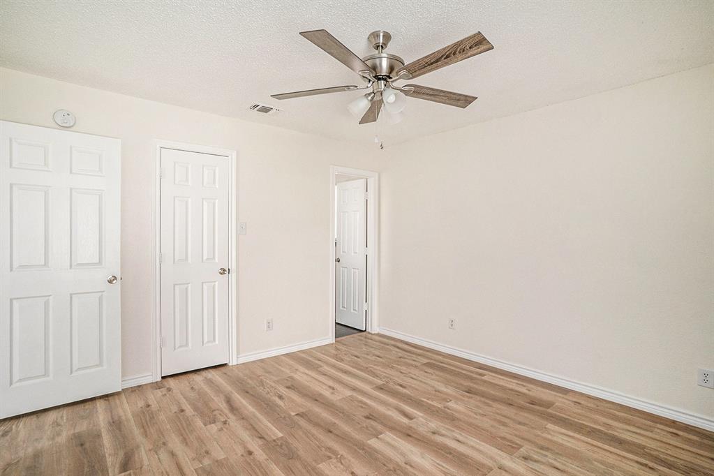 602 McAnear Street Cleburne, TX 76033 - Photo 14 of 27 wooden floor in an empty room