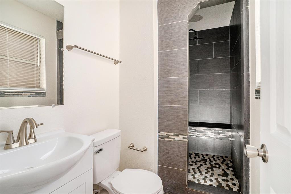 602 McAnear Street Cleburne, TX 76033 - Photo 16 of 27 a bathroom with a toilet and shower