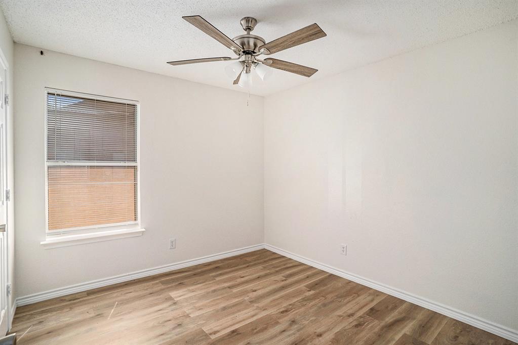 602 McAnear Street Cleburne, TX 76033 - Photo 17 of 27 an empty room with a window and a fan