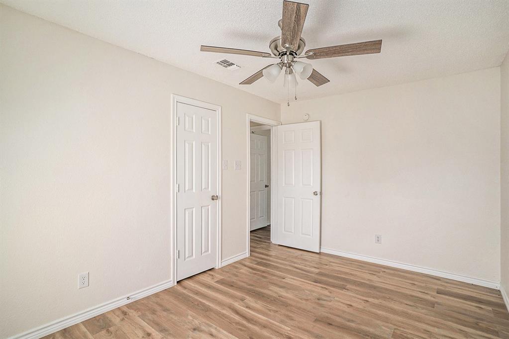 602 McAnear Street Cleburne, TX 76033 - Photo 20 of 27 a view of a room with wooden floor and fan