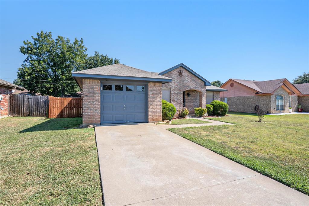602 McAnear Street Cleburne, TX 76033 - Photo 2 of 27 a front view of a house with a garden