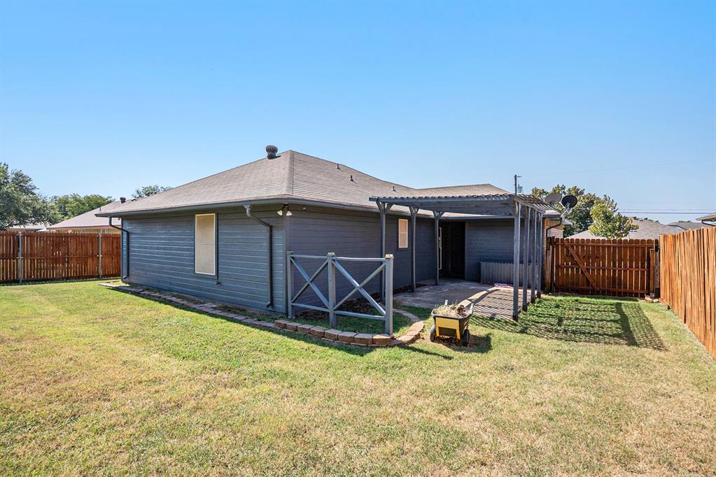 602 McAnear Street Cleburne, TX 76033 - Photo 24 of 27 a view of backyard with table and chairs