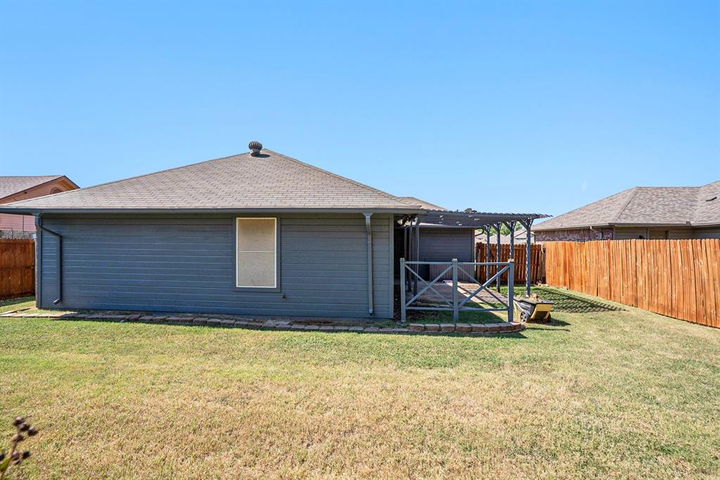 602 McAnear Street Cleburne, TX 76033 - Photo 25 of 27 a house with wooden fence