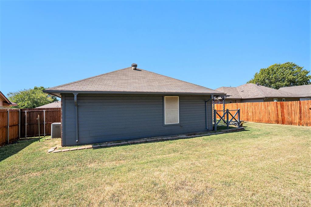 602 McAnear Street Cleburne, TX 76033 - Photo 26 of 27 a house with wooden fence
