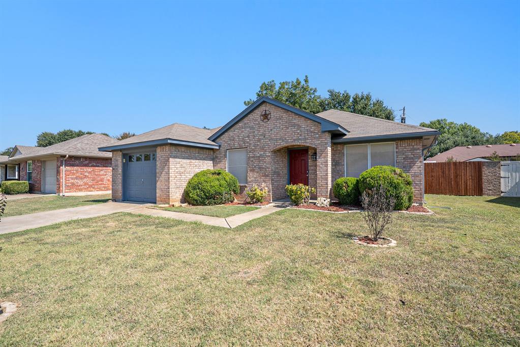 602 McAnear Street Cleburne, TX 76033 - Photo 3 of 27 a view of a house with a yard and garage