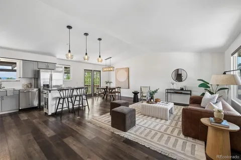 a living room with furniture a table and chairs
