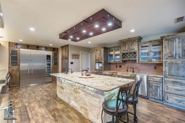 a large kitchen with a table and chairs