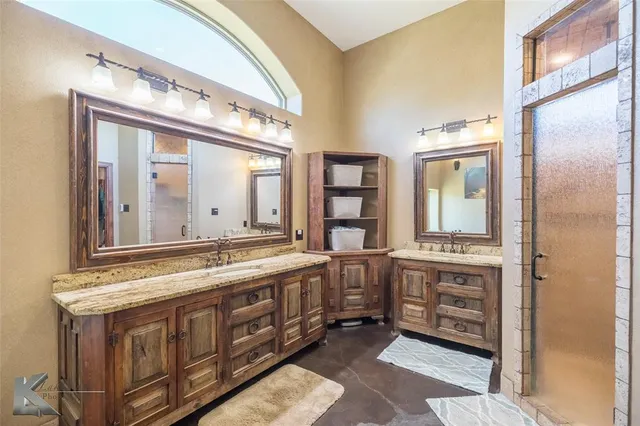 a bathroom with a double vanity sink and a mirror