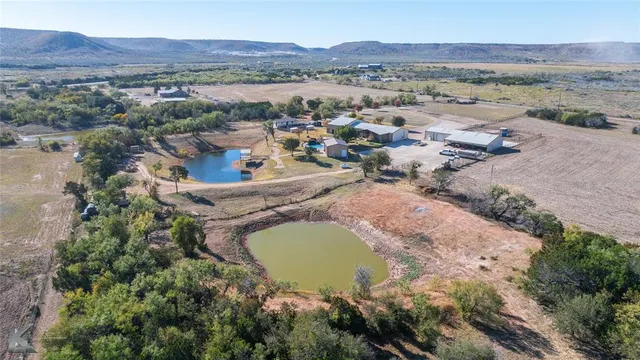 an aerial view of residential house with outdoor space and river