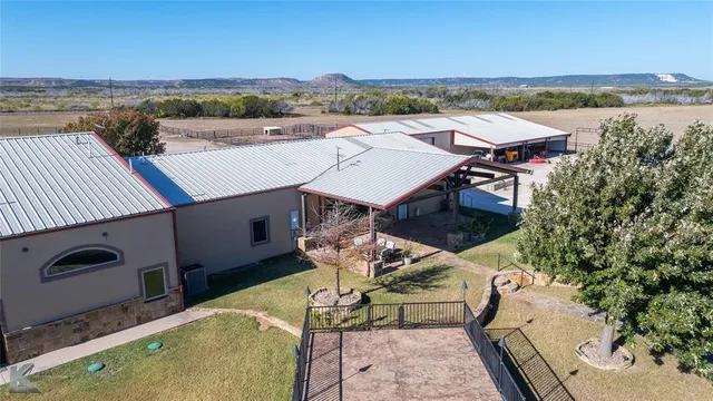 aerial view of a house with pool and chairs