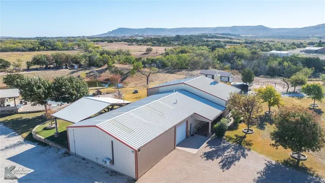 an aerial view of a house with pool