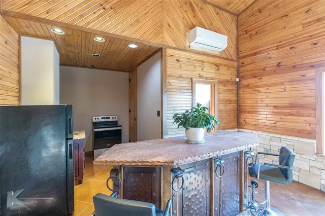 a view of a patio with table and chairs potted plants
