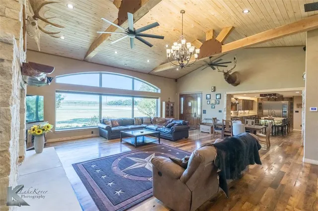 a living room with furniture or chandelier and a large window