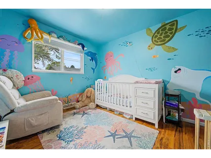 a bedroom with furniture and a baby crib