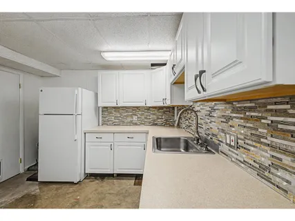 a kitchen with cabinets and white appliances