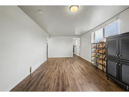 a view of a room with wooden floor