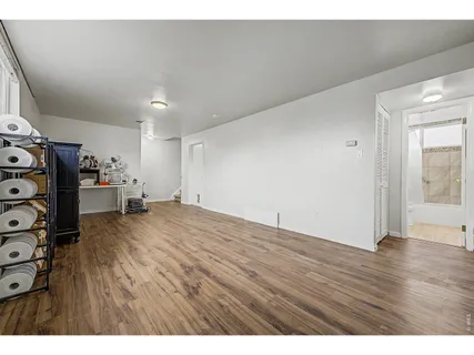 a view of empty room with wooden floor