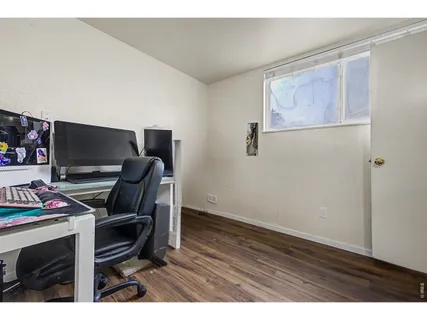 a view of a workspace with furniture and wooden floor