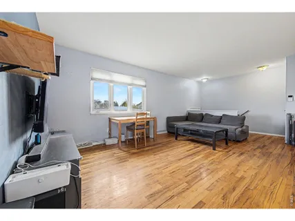 a living room with furniture a piano and a flat screen tv