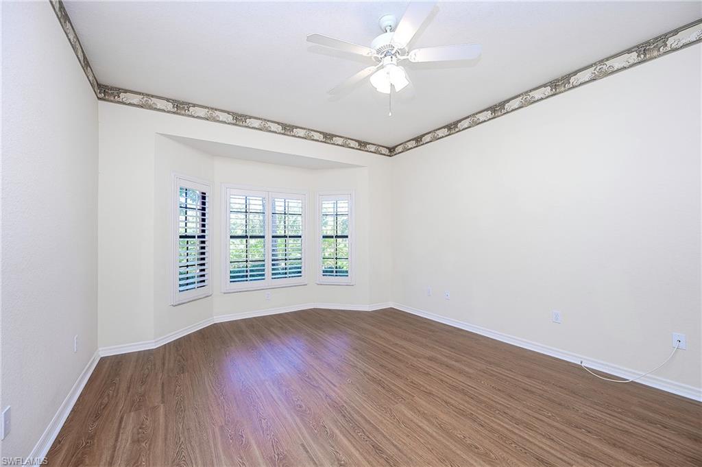 5805 Grande Reserve Way, Unit 1102 Naples, FL 34110 - Photo 15 of 38 a view of an empty room with wooden floor and a window