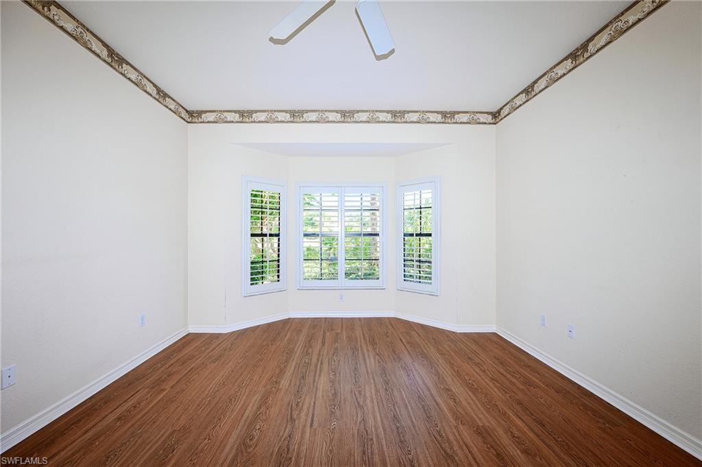 5805 Grande Reserve Way, Unit 1102 Naples, FL 34110 - Photo 16 of 38 a view of a room with wooden floor and windows