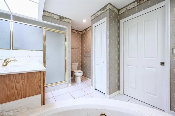 a large white tub sitting in a bathroom