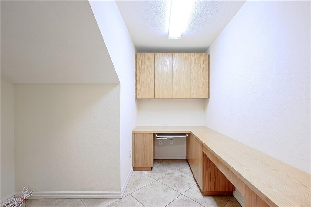 5805 Grande Reserve Way, Unit 1102 Naples, FL 34110 - Photo 24 of 38 a room with a sink and a mirror