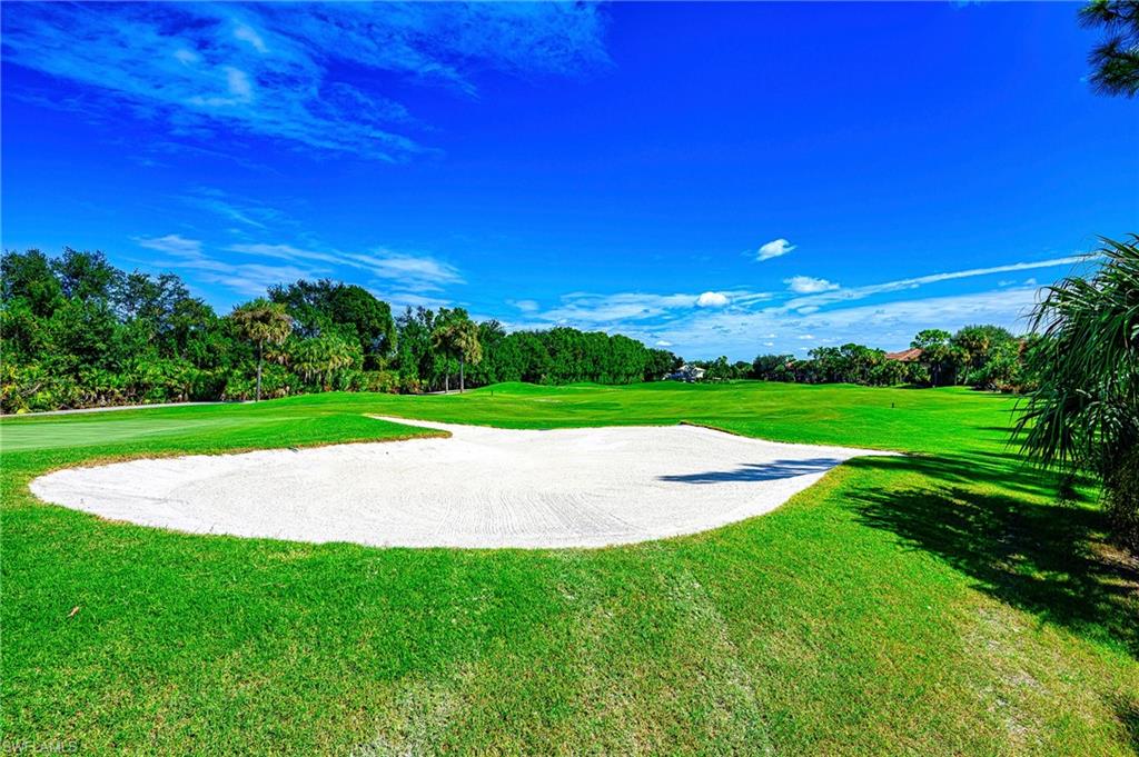 5805 Grande Reserve Way, Unit 1102 Naples, FL 34110 - Photo 30 of 38 a view of a golf course with a garden