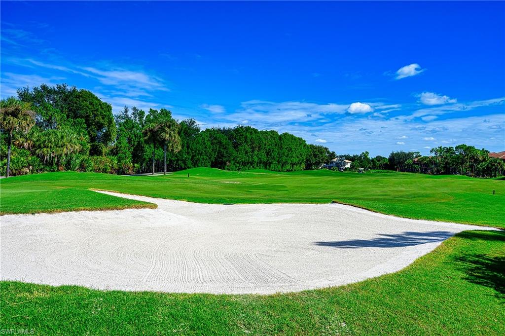 5805 Grande Reserve Way, Unit 1102 Naples, FL 34110 - Photo 32 of 38 a view of a golf course with a yard