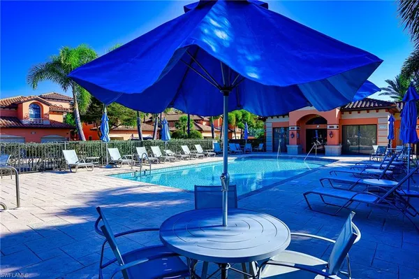 a front view of a house with swimming pool patio and fire pit
