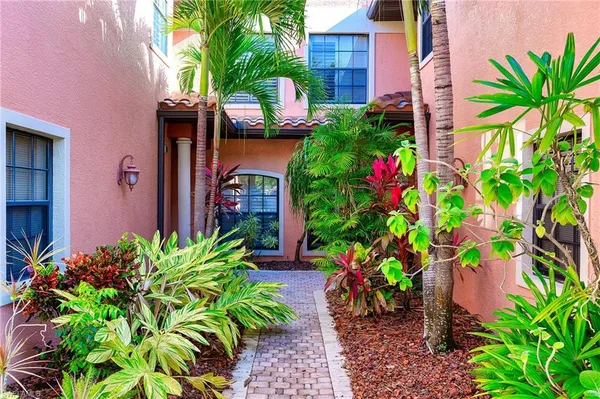 a view of a house with potted plants