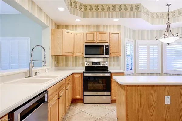 a kitchen with stainless steel appliances a stove sink and microwave