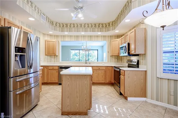 a kitchen with a refrigerator and a sink