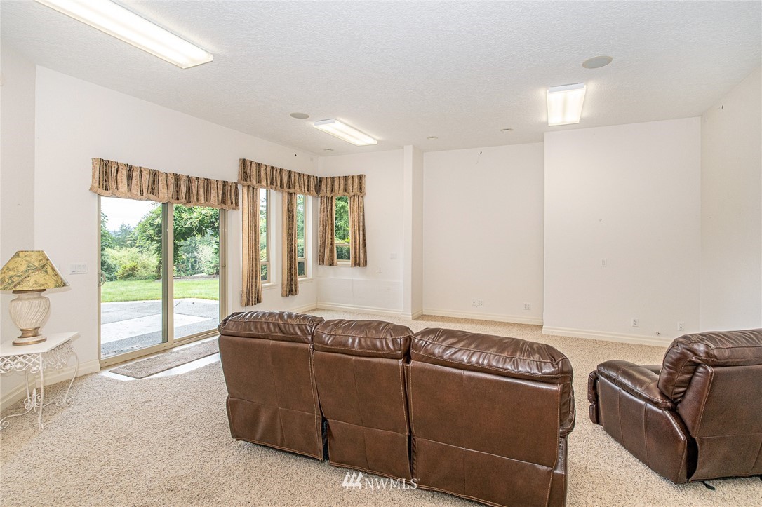 208 Brockway Road Chehalis, WA 98532 - Photo 22 of 40 a living room with furniture and a floor to ceiling window