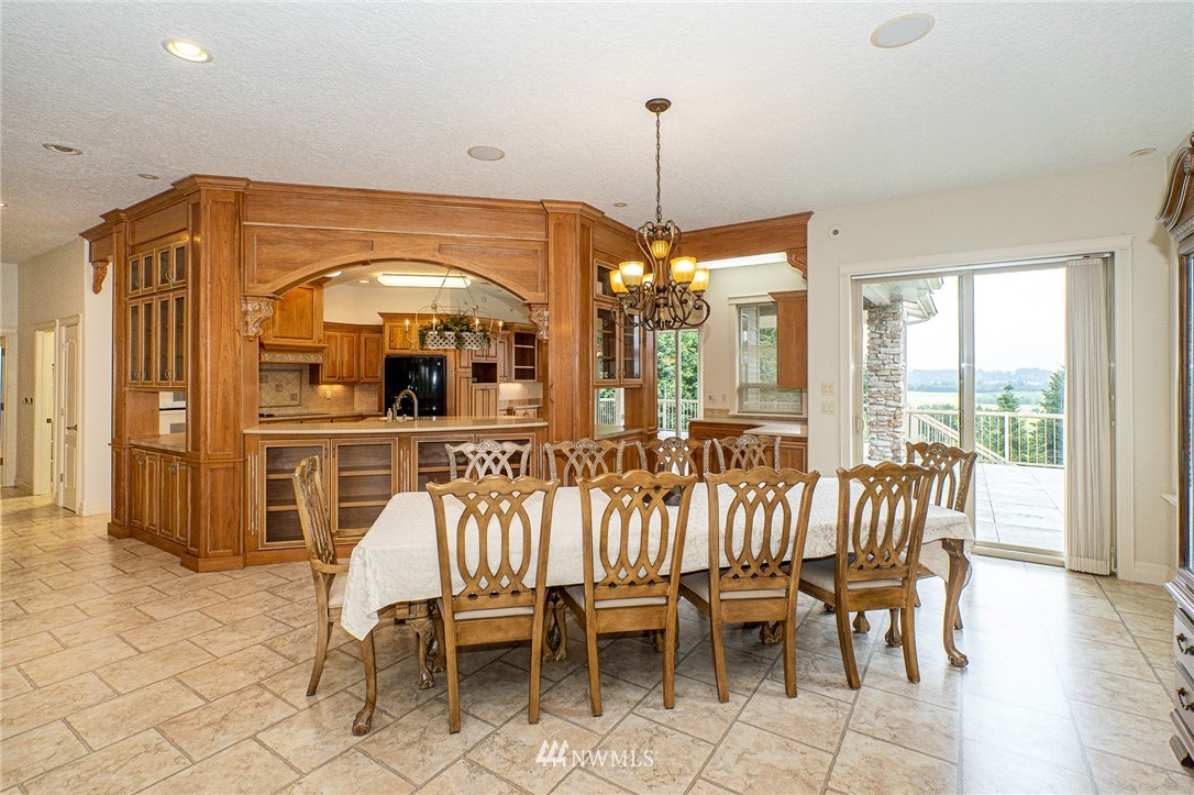 208 Brockway Road Chehalis, WA 98532 - Photo 10 of 40 a view of a dining room with furniture wooden floor and chandelier