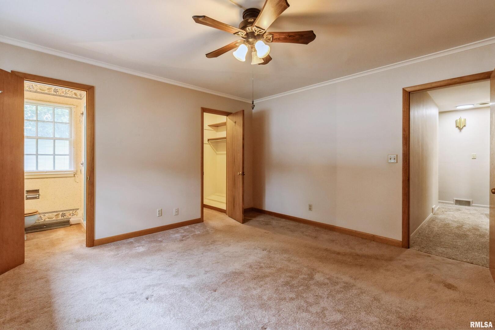 1136 Bobetta Court Clinton, IA 52732 - Photo 18 of 28 an empty room with closet and a chandelier fan