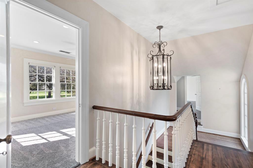8530 Jourdan Way Dallas, TX 75225 - Photo 16 of 39 Stairs featuring a chandelier and wood finished floors