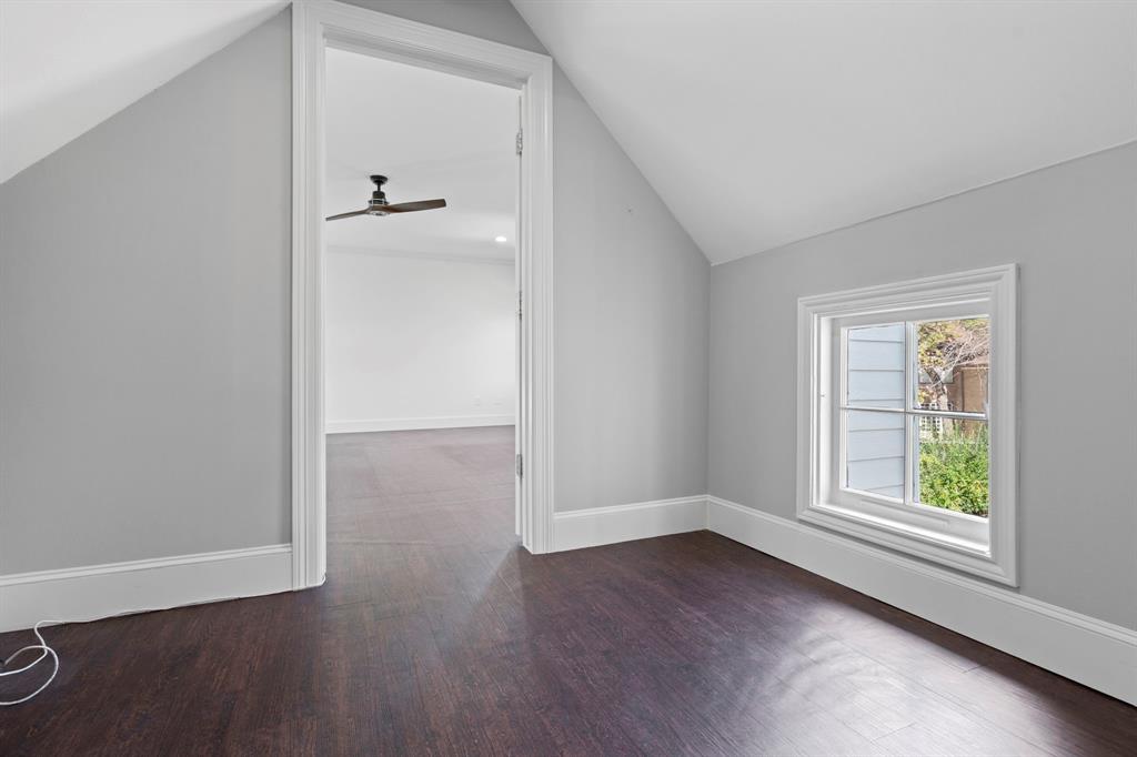 8530 Jourdan Way Dallas, TX 75225 - Photo 18 of 39 Bonus room with dark wood-style floors, lofted ceiling, and ceiling fan