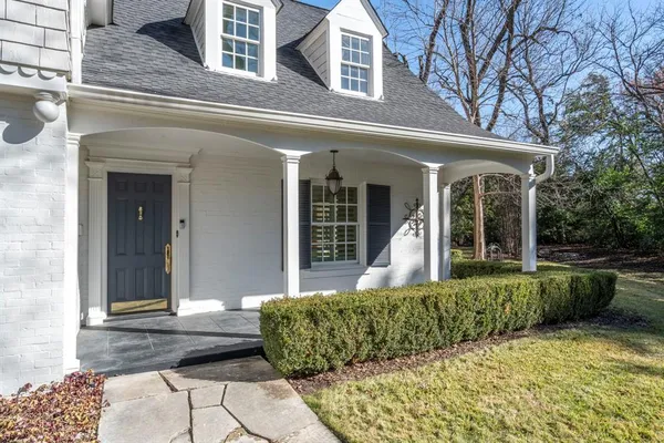 front view of a house with a floor to ceiling window