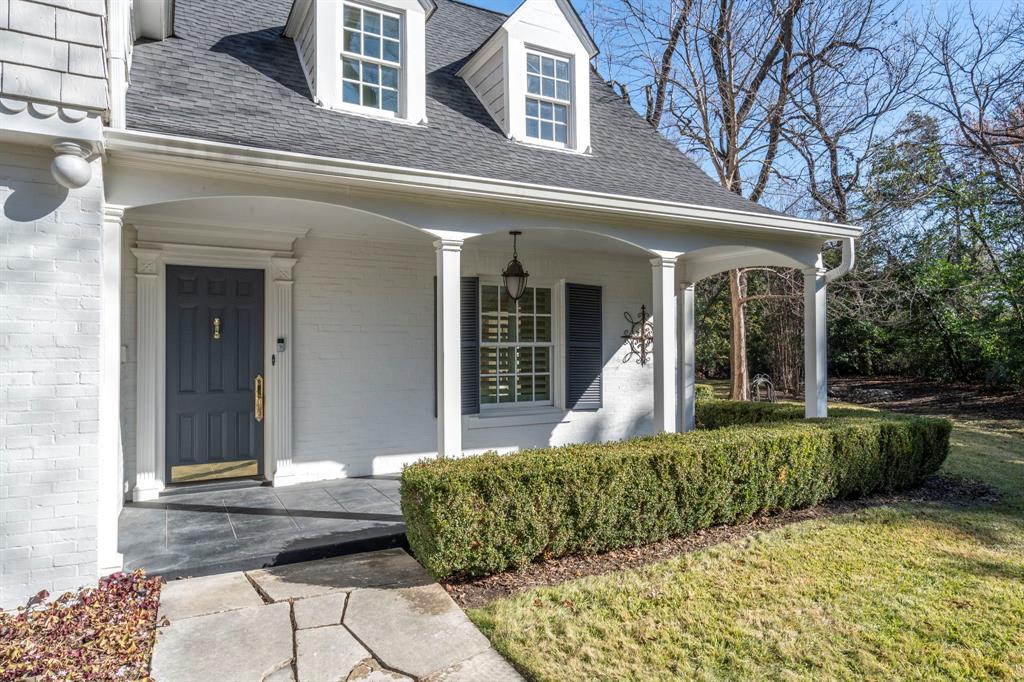 8530 Jourdan Way Dallas, TX 75225 - Photo 3 of 39 Property entrance with a porch, a shingled roof, brick siding, and a yard