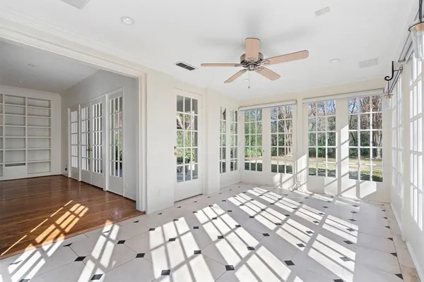 a view of a bedroom with wooden floor and windows